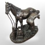 A resin figure of a Farrier, together with a further figure of a jockey on horseback, tallest 26cm.