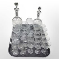 Two 19th-century etched crystal decanters and similar drinking glasses.