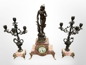 A French spelter and rouge marble three-piece clock garniture, height 59cm.