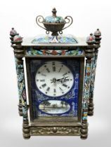 A champleve enamel mantel clock containing a battery movement,