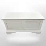 A contemporary white blanket chest,