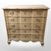 A Danish blond oak serpentine fronted chest of five drawers,