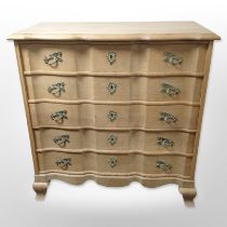A Danish blond oak serpentine fronted chest of five drawers,