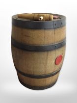 A coopered oak wine keg, height 35cm, together with a pair of black leather riding boots.