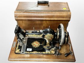An antique Jones sewing machine in box