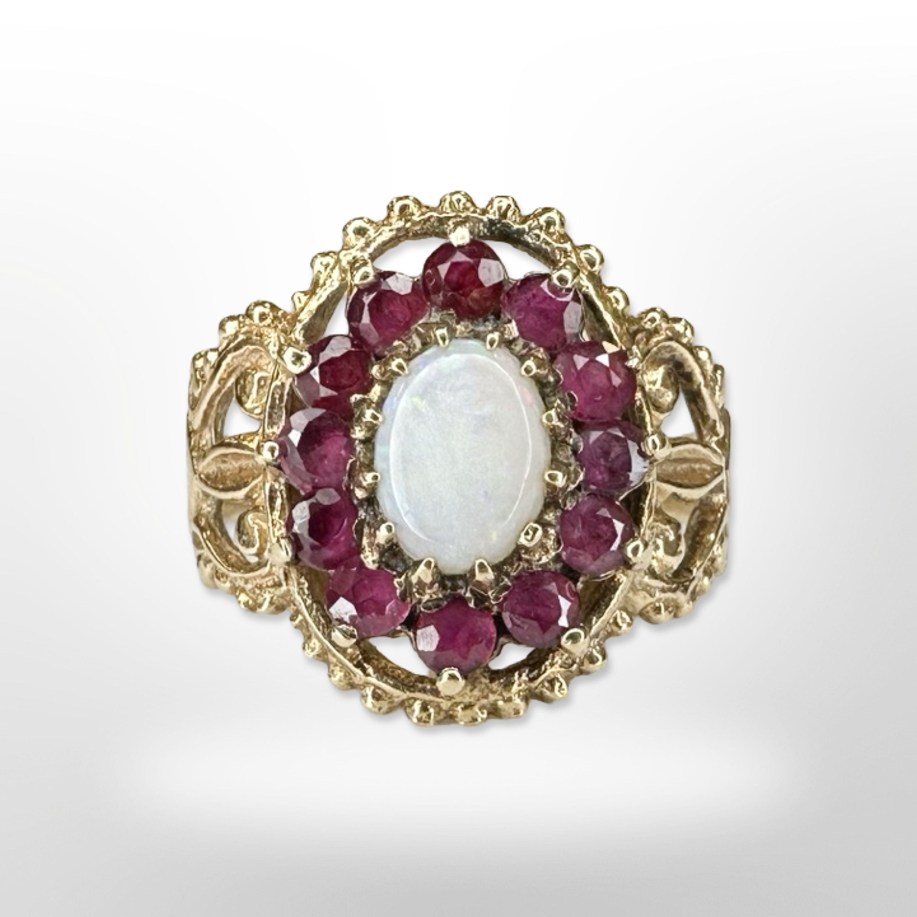 A 9ct yellow gold ruby and opal cluster ring, size M/N. CONDITION REPORT: 3.5g.