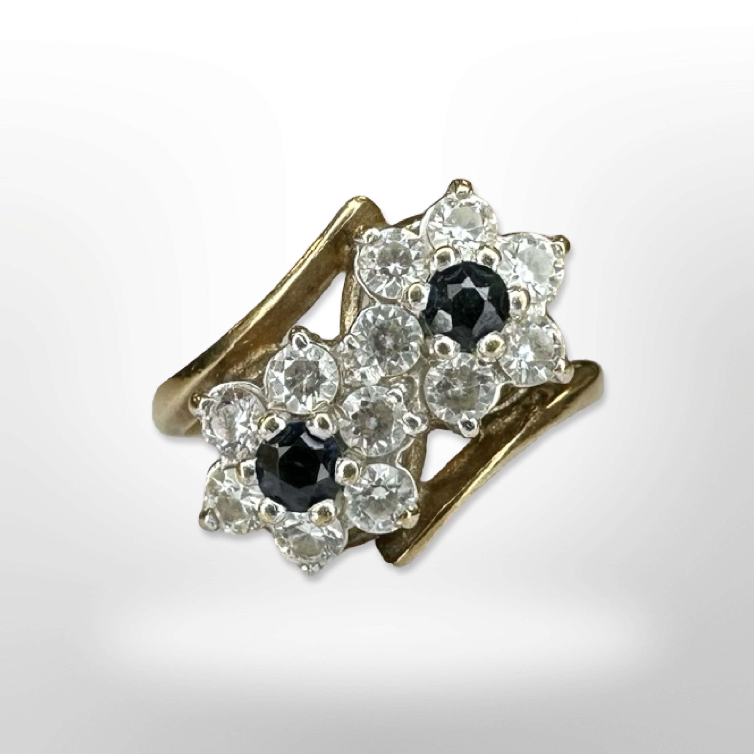 A 9ct yellow gold sapphire and zircon cluster ring with double flower head, size L.