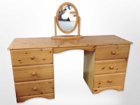 A contemporary pine six drawer dressing table,