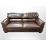 A contemporary brown stitched leather three seater settee,