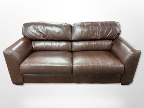 A contemporary brown stitched leather three seater settee,