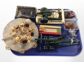 A group of toys including rattle, turned wooden spinning top, die cast field guns, tambourine,