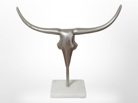 A cast metal Steer skull on plinth,