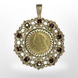 An 1894 22ct gold half sovereign coin mounted in 9ct yellow gold set with garnets as a pendant.