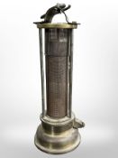 A 19th century brass Davy lamp with gauze casing, stamped 'Made in Wales'.