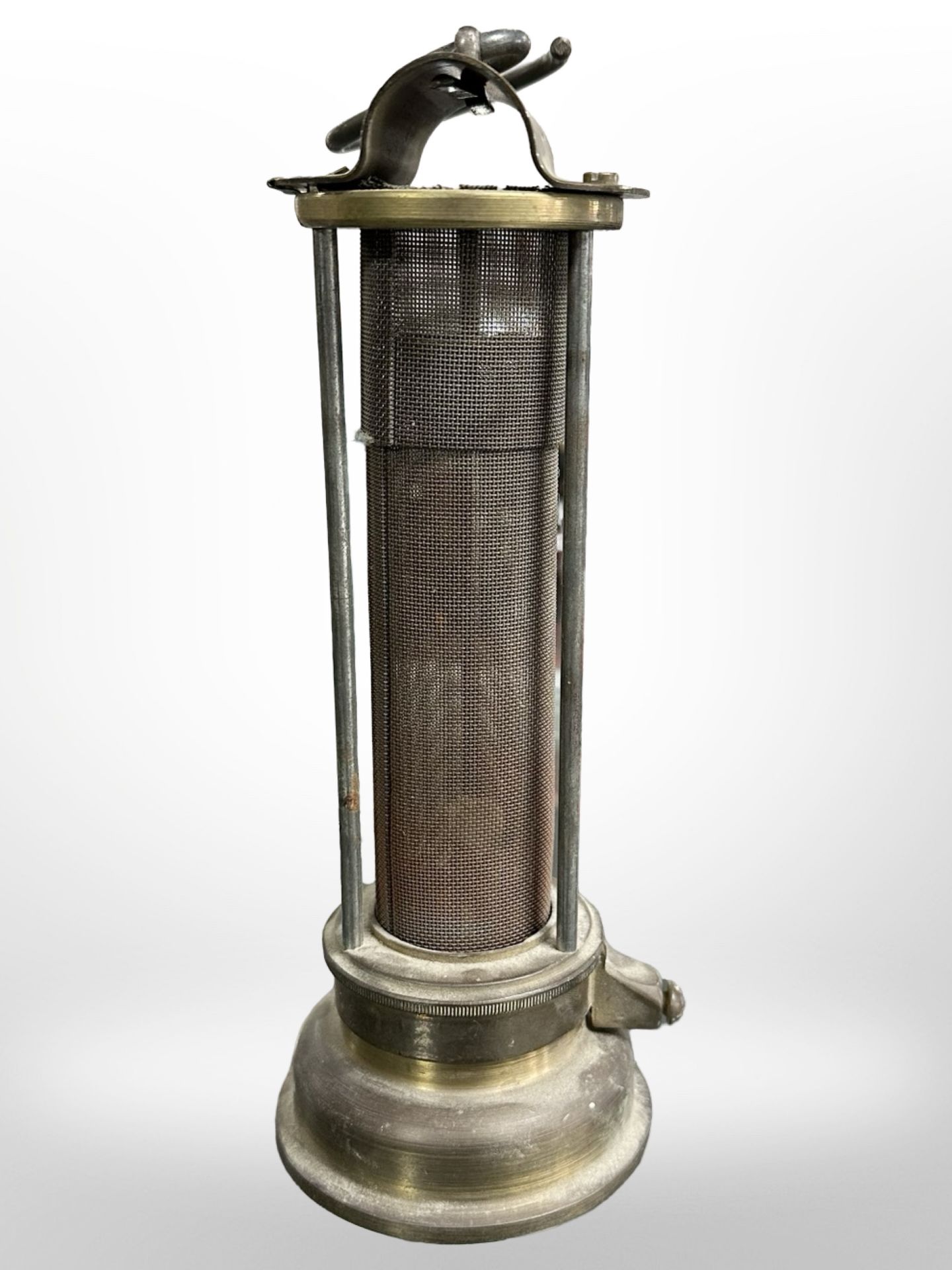 A 19th century brass Davy lamp with gauze casing, stamped 'Made in Wales'.