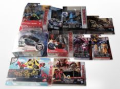 Nine Hasbro and other Transformers figurines, boxed.
