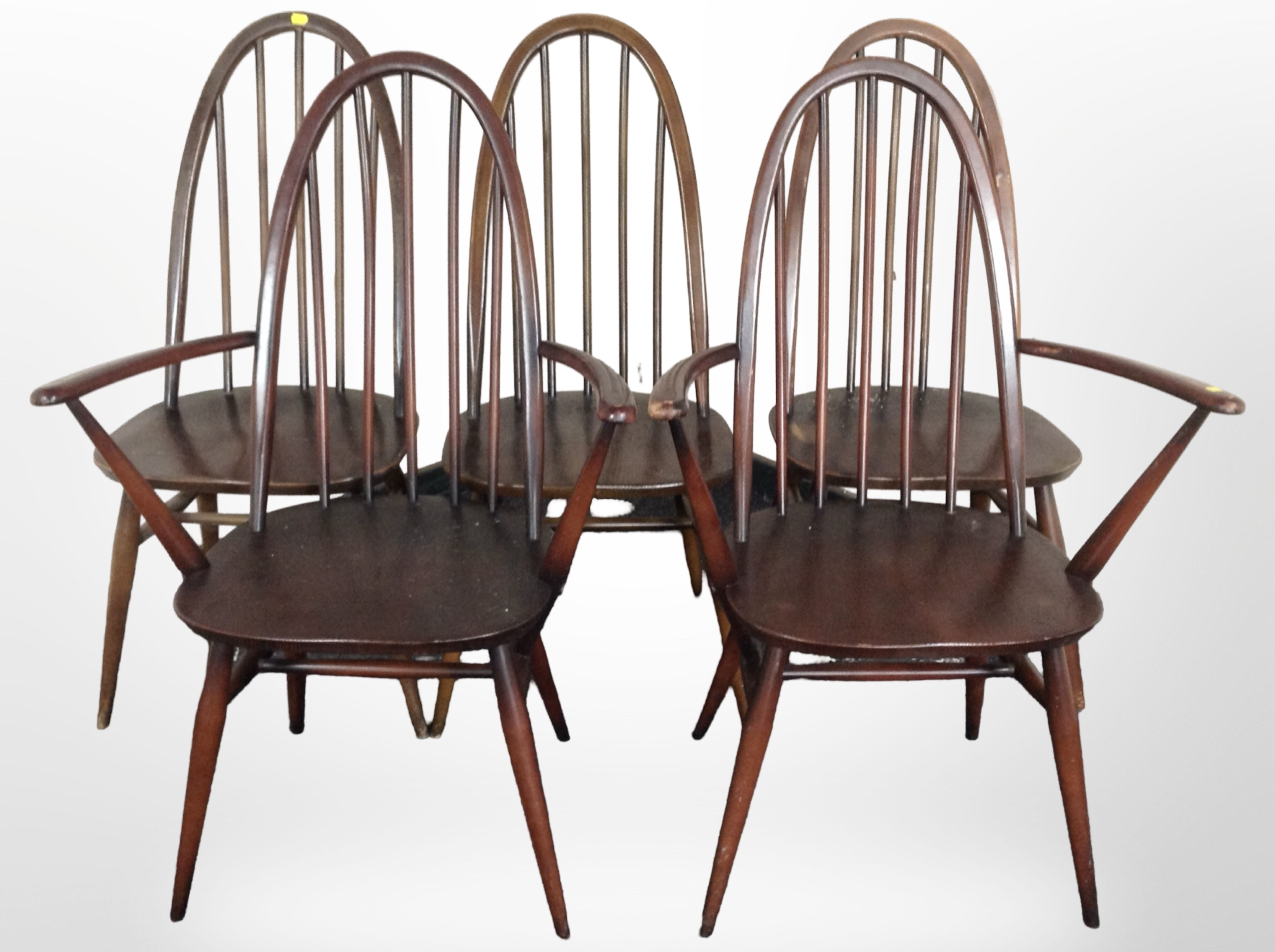 A pair of Ercol stained elm armchairs and three similar single chairs