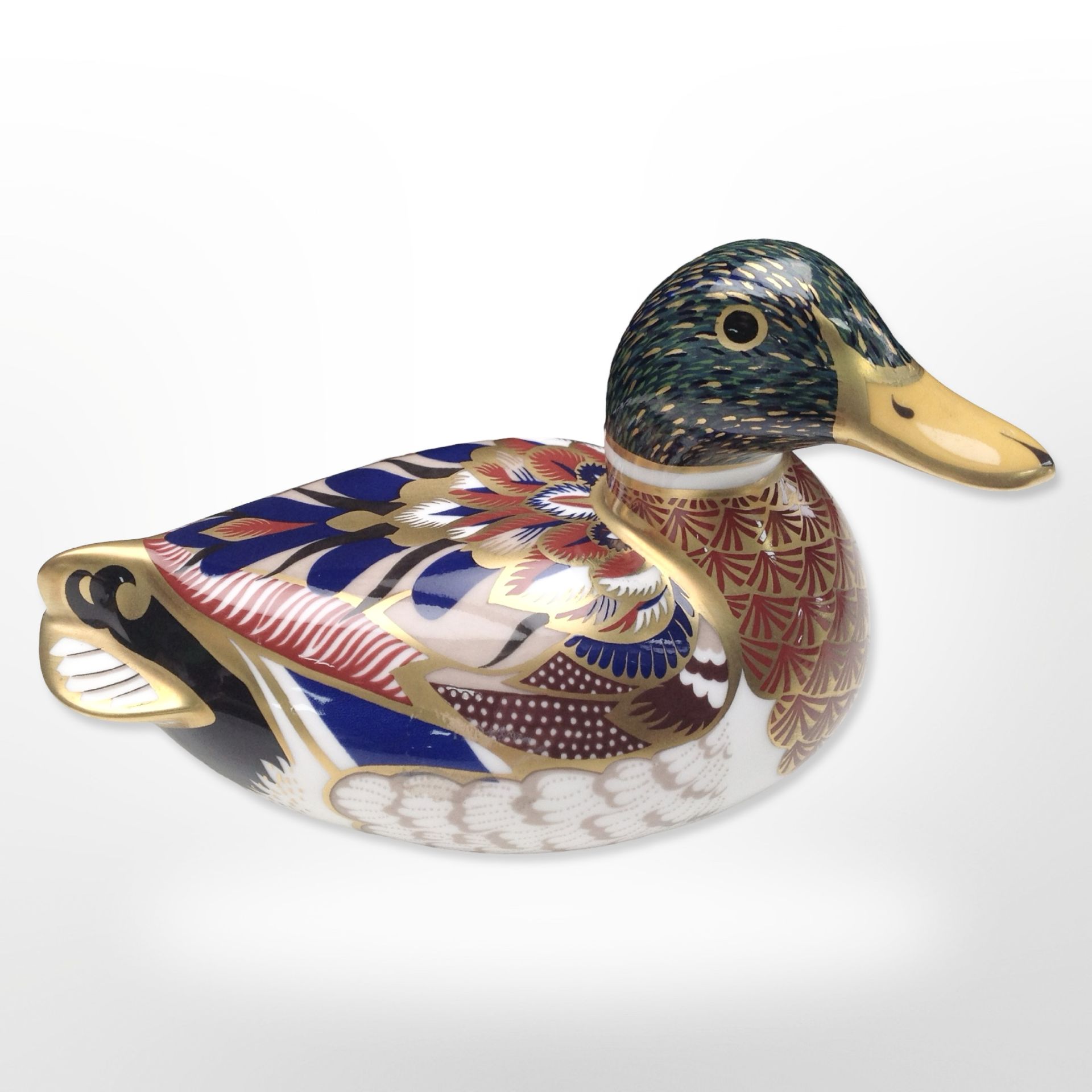 A Royal Crown Derby duck paperweight with gold stopper.