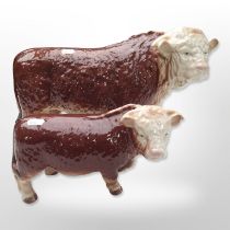 Two Melba ware cows, largest 43cm long.