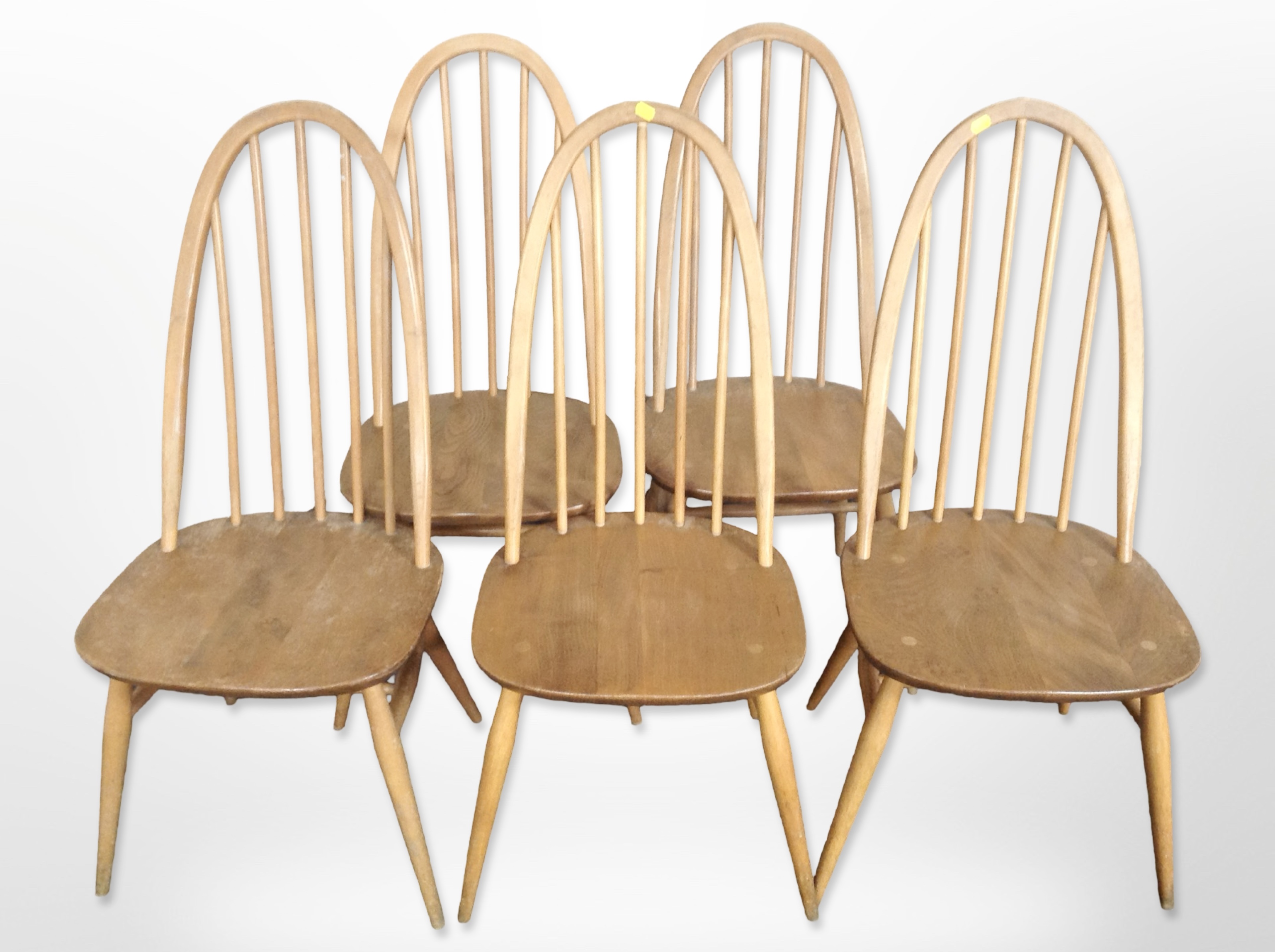 A set of five Ercol light elm and beech spindle back dining chairs