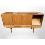 A 20th century Danish teak sliding door sideboard, fitted with four drawers raised on tapering legs,
