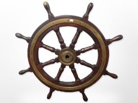 A reproduction mahogany and brass ship's wheel,