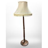 A turned beech standard lamp with tasseled shade