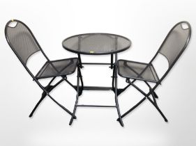 A folding wire metal circular garden table and two chairs together with a wicker fruit bowl