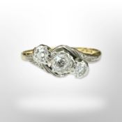 An 18ct yellow gold three stone diamond ring, size N. CONDITION REPORT: 2.5g.
