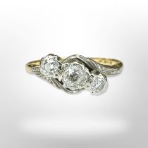 An 18ct yellow gold three stone diamond ring, size N. CONDITION REPORT: 2.5g.