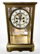 A French gilt brass and bevelled glass 8-day mantel clock, striking on a bell with Mercury pendulum,