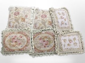 A group of tasselled tapestry cushions.