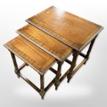 A reproduction nest of three inlaid mahogany tables,
