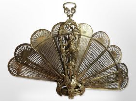 A brass 'peacock' fire screen, height 85cm.