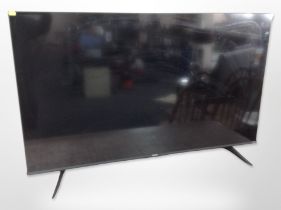 A Hisense 54-inch LCD TV with lead, remote and manual.