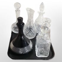 A group of five modern crystal decanters and a flower vase