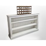 A painted open bookcase 153 cm wide x 31 cm deep x 92 cm high together with a bottle rack