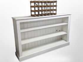 A painted open bookcase 153 cm wide x 31 cm deep x 92 cm high together with a bottle rack