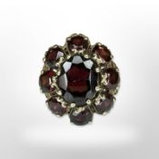 A yellow gold garnet cluster ring, size N/O. CONDITION REPORT: 6g.