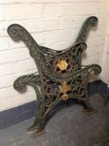 A pair of painted cast iron bench ends