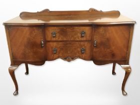 A walnut serpentine fronted sideboard on cabriole legs 149 cm wide x 54 cm deep x 97 cm high