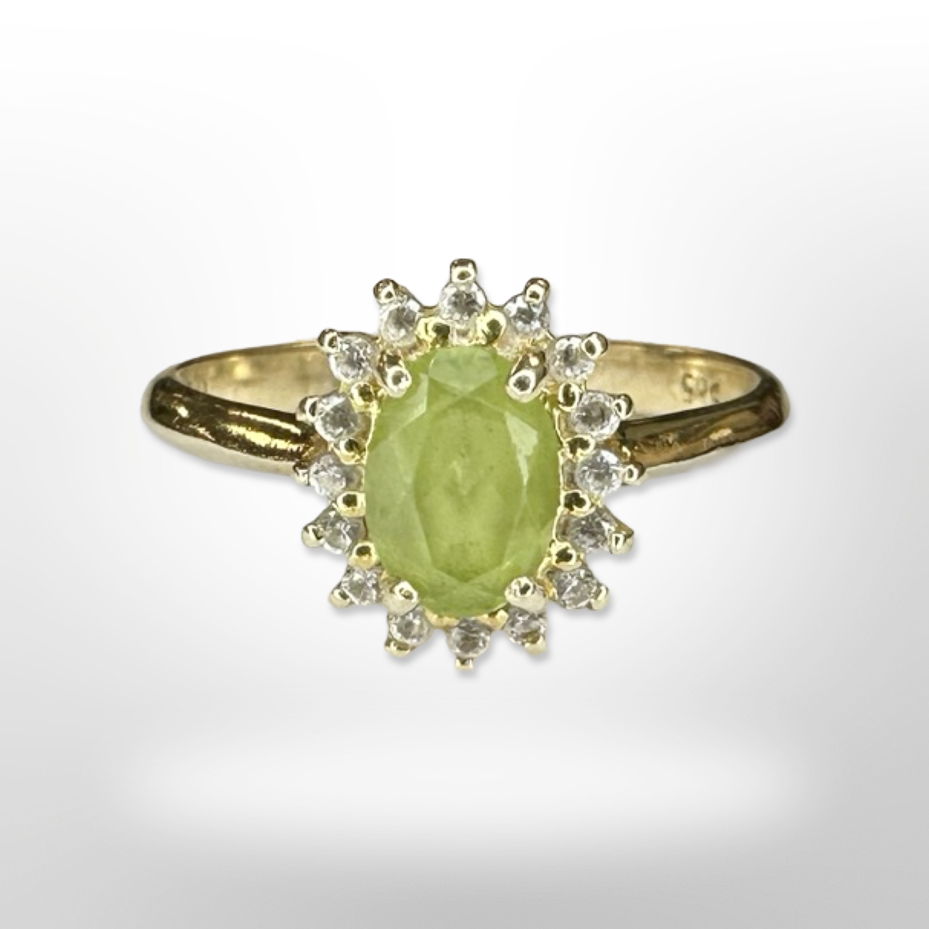 A 14ct yellow gold peridot diamond cluster ring, size N/O. CONDITION REPORT: 2.