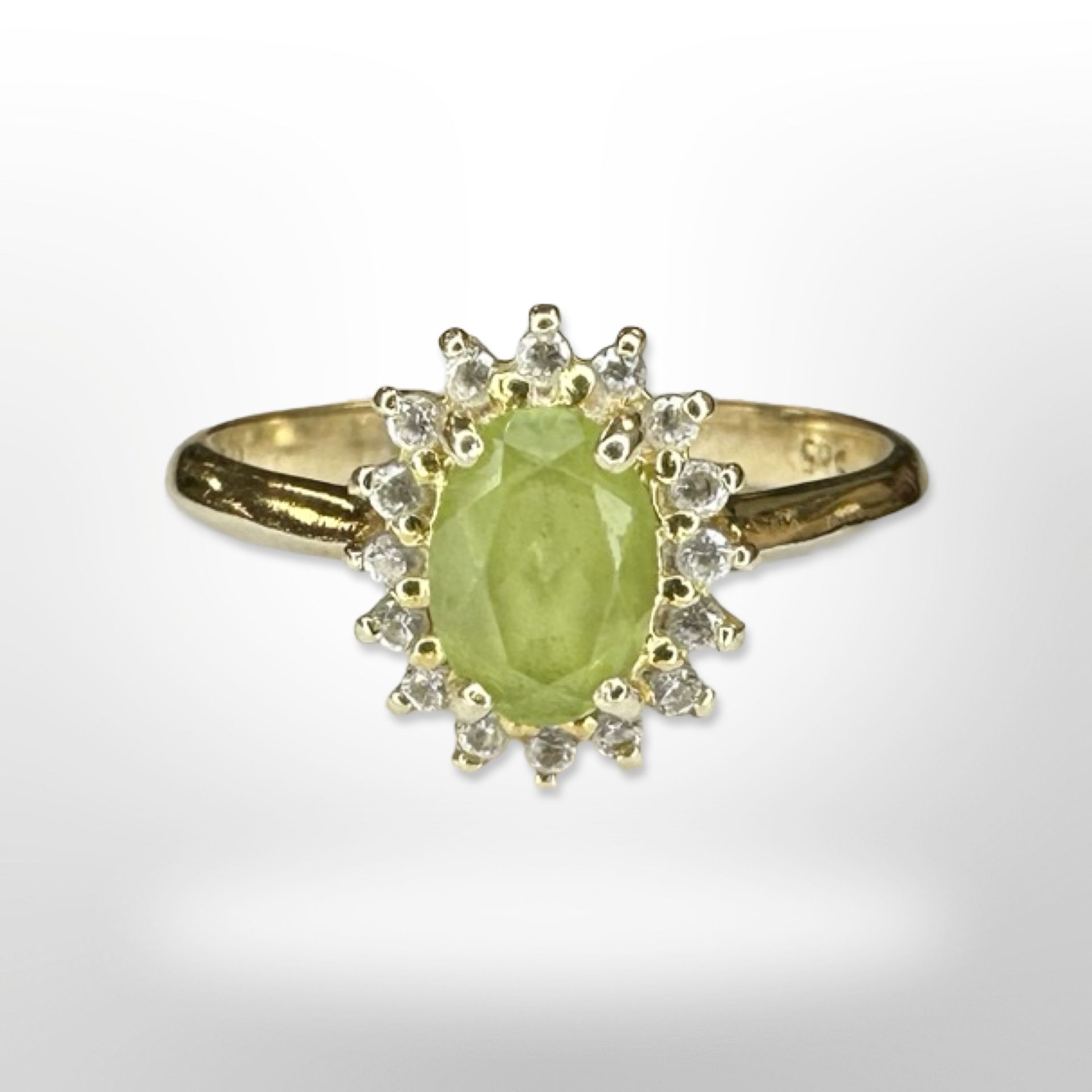 A 14ct yellow gold peridot diamond cluster ring, size N/O. CONDITION REPORT: 2.