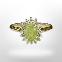 A 14ct yellow gold peridot diamond cluster ring, size N/O. CONDITION REPORT: 2.