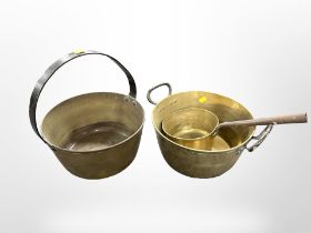 Two brass jam pans and a further long-handled sauce pan.