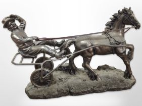 A resin figure of a man riding a horsetrap, length 31cm.