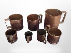 A group of graduated 19th century copper tankards,