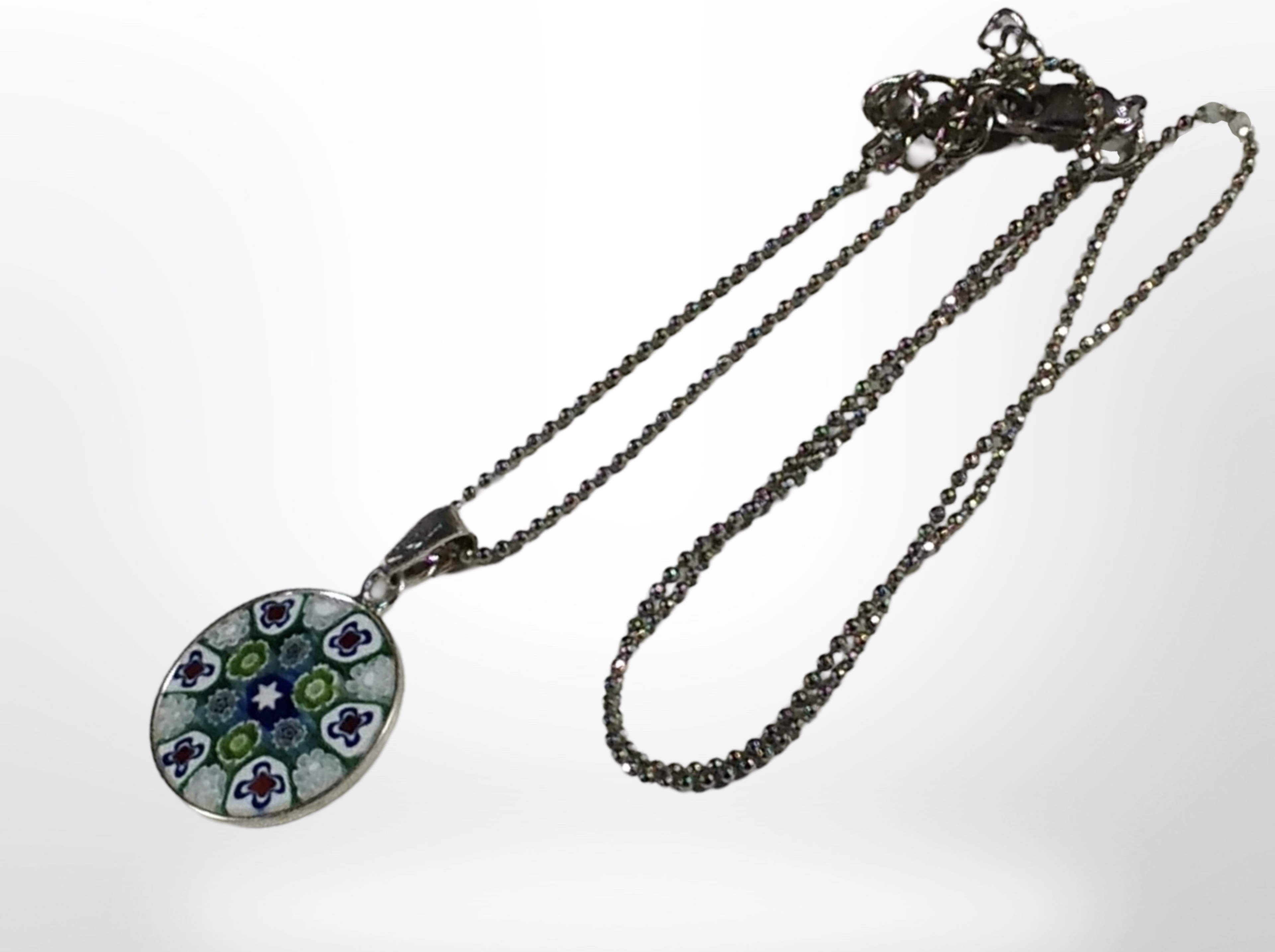 A silver-mounted Italian glass Millefiori pendant on silver ball chain.