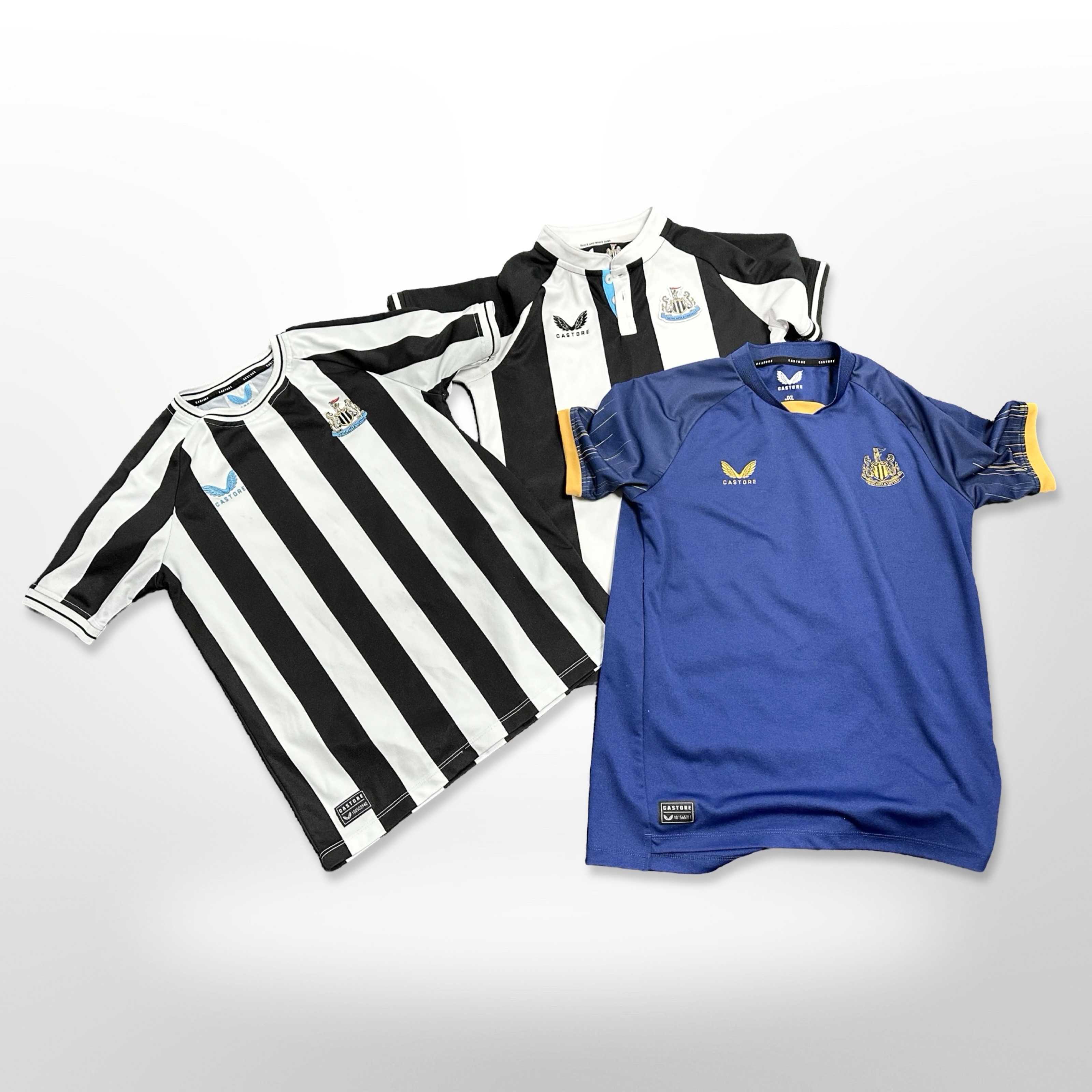 Three official Newcastle United football shirts,