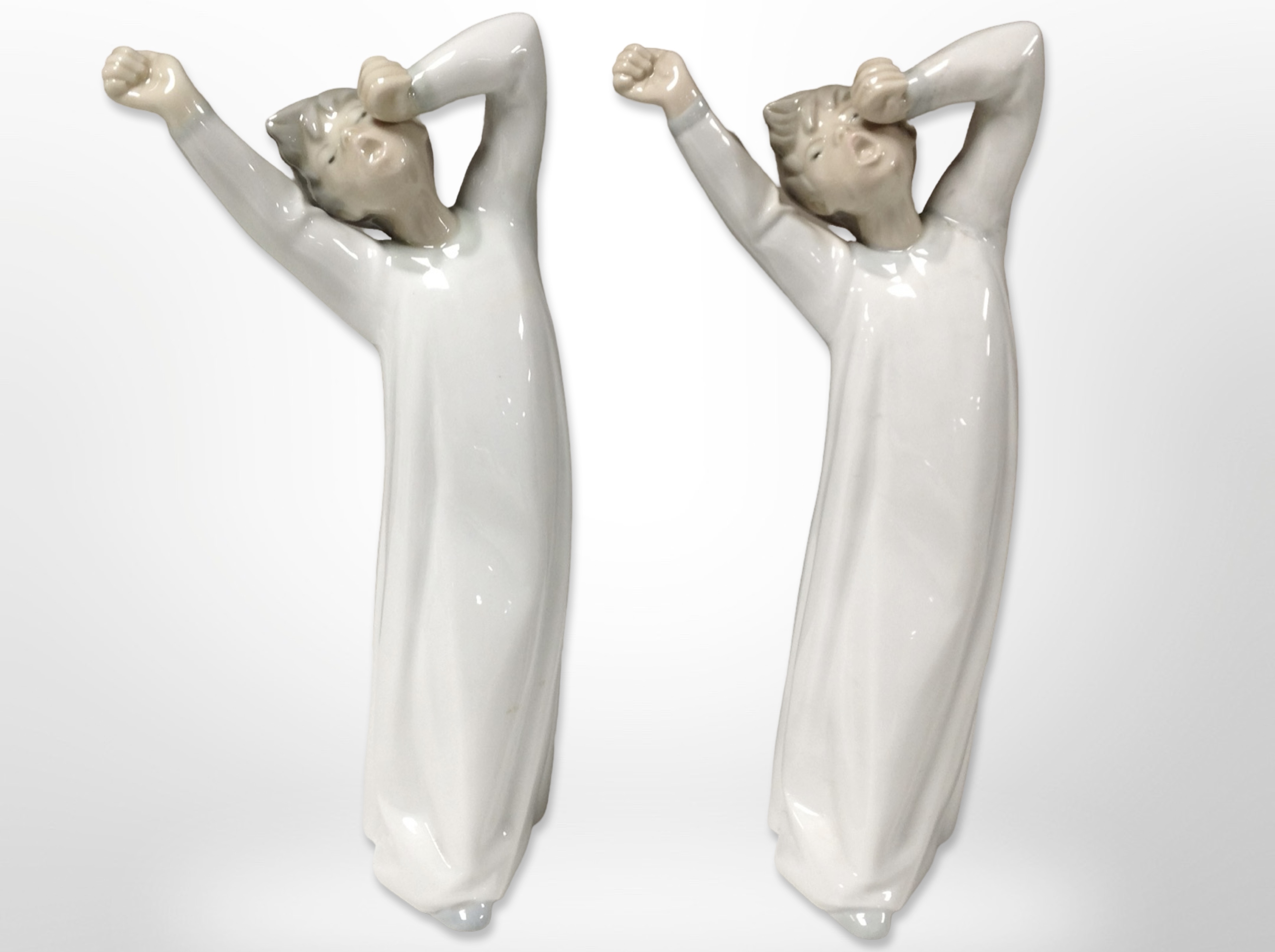 Two matching Lladró figures of boys in nightgowns, height 21cm.